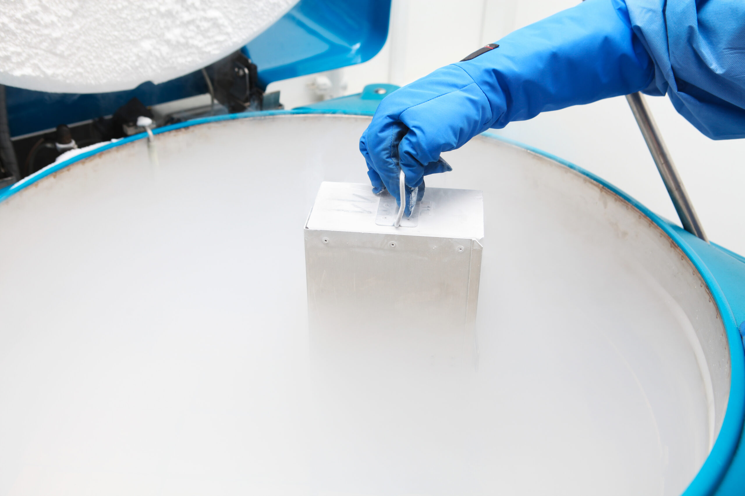 Container with liquid nitrogen...doctor in hazmat suit at work